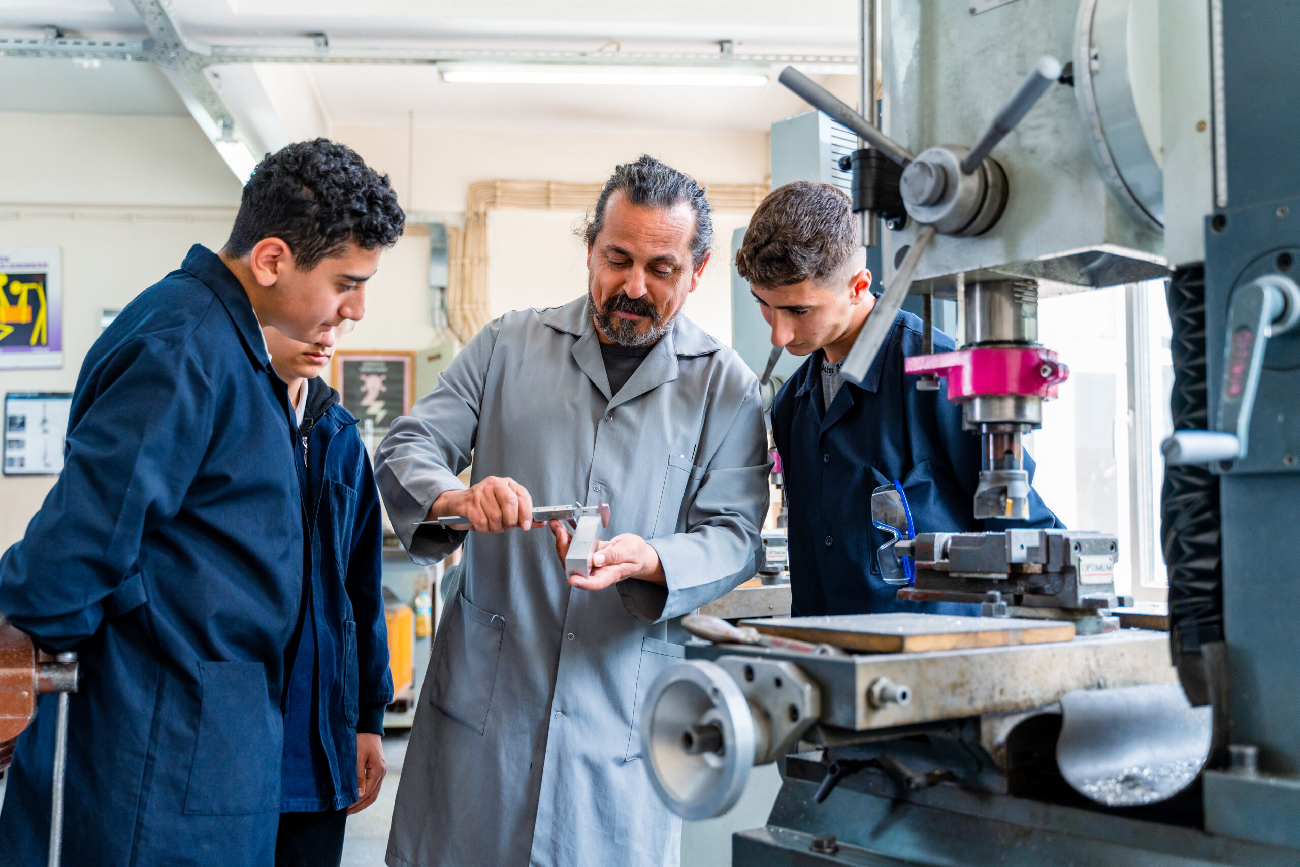 Group of young people in technical vocational training with teacher